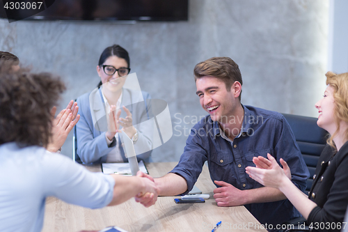 Image of cloasing the deal in modern office interior