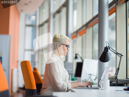 Image of businesswoman using a laptop in startup office