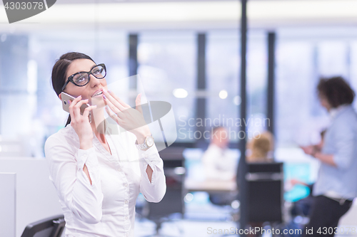 Image of Elegant Woman Using Mobile Phone in startup office building