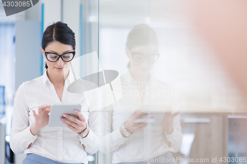 Image of Business Woman Using Digital Tablet in front of startup Office