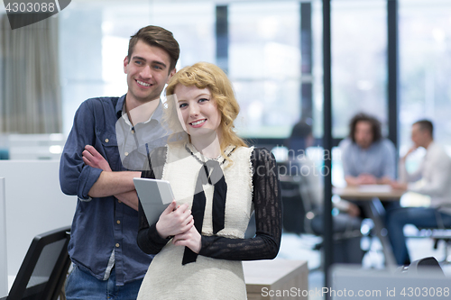 Image of Business People Working With Tablet in startup office