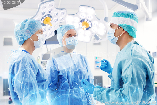 Image of group of surgeons in operating room at hospital