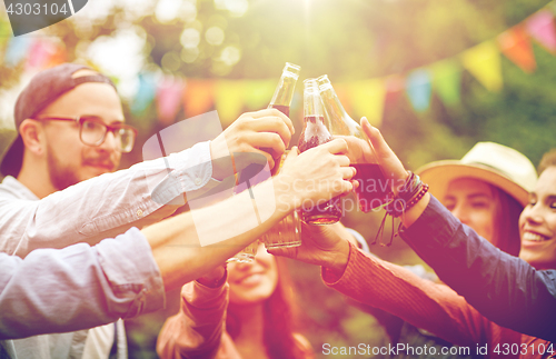Image of happy friends clinking glasses at summer garden