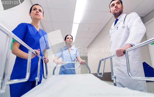 Image of medics carrying hospital gurney at emergency