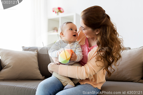 Image of happy young mother with little baby at home