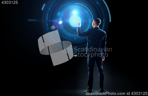 Image of businessman in suit touching virtual projection
