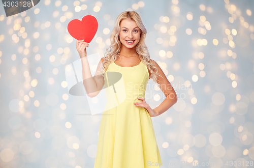 Image of happy young woman with red paper heart