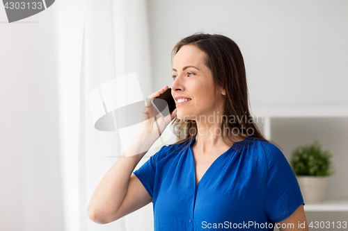 Image of woman calling on smartphone at office or home