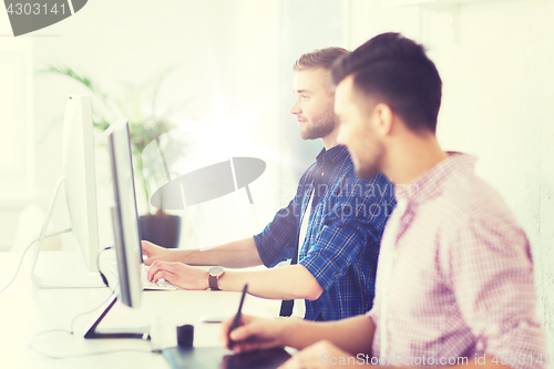 Image of creative man or student with computer at office