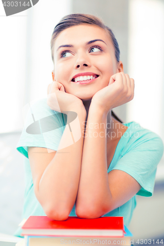 Image of happy smiling student girl with books