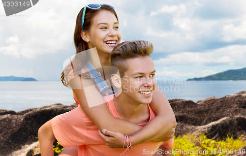 Image of happy teenage couple having fun outdoors