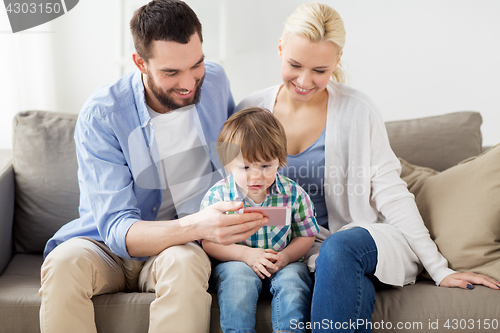 Image of happy family with smartphone at home