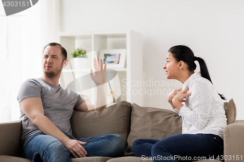 Image of unhappy couple having argument at home