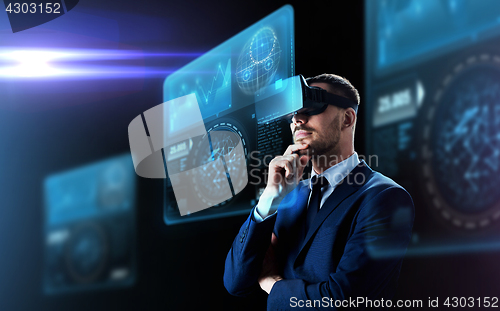 Image of businessman in virtual reality headset and screens