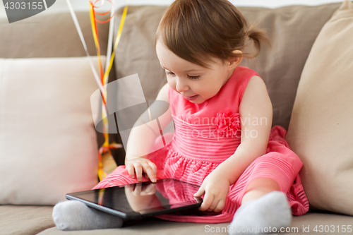 Image of baby girl with tablet pc at home