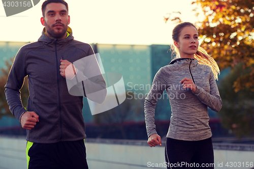 Image of couple running outdoors