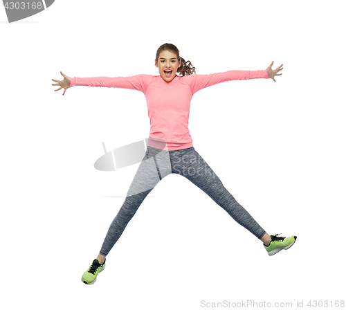Image of happy smiling sporty young woman jumping in air