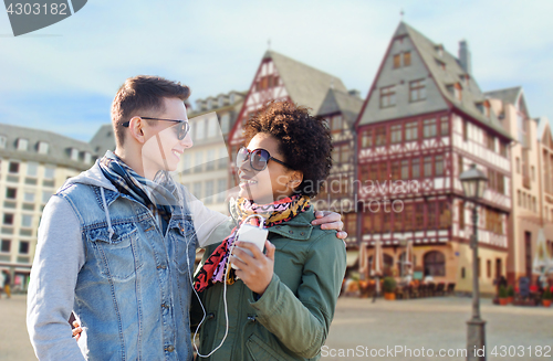 Image of couple with smartphone and earphones in frankfurt