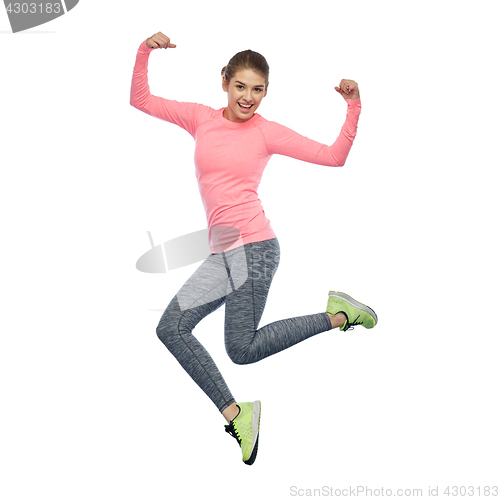 Image of happy smiling sporty young woman jumping in air