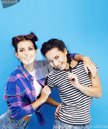 Image of best friends teenage school girls together having fun, posing emotional on blue background, besties happy smiling, lifestyle people concept 