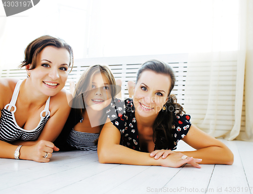 Image of Mature sisters twins at home with little daughter, happy family 