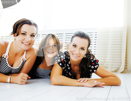 Image of Mature sisters twins at home with little daughter, happy family 
