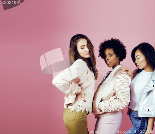 Image of different nation girls with diversuty in skin, hair. Asian, scandinavian, african american cheerful emotional posing on pink background, woman day celebration, lifestyle people concept 