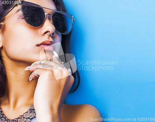 Image of lifestyle people concept. young pretty smiling indian girl with long nails wearing lot of jewelry rings, asian summer happy cool close up