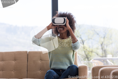 Image of black woman using VR headset glasses of virtual reality