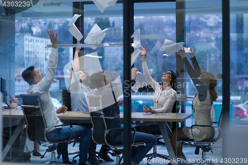 Image of startup Group of young business people throwing documents