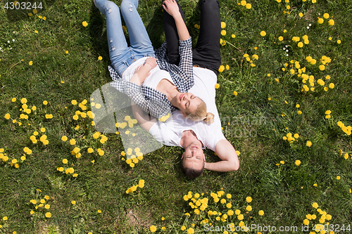 Image of man and woman lying on the grass