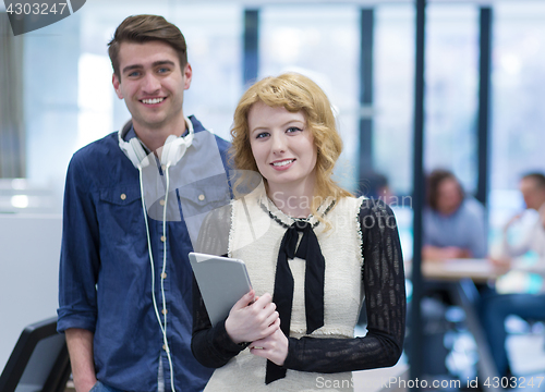 Image of Business People Working With Tablet in startup office