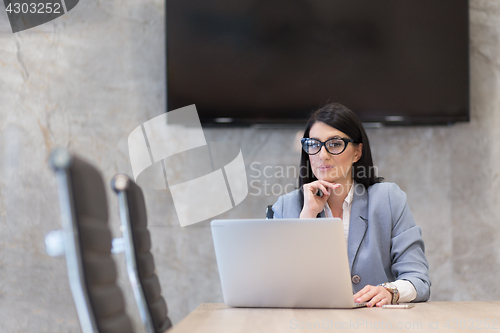 Image of businesswoman using a laptop in startup office