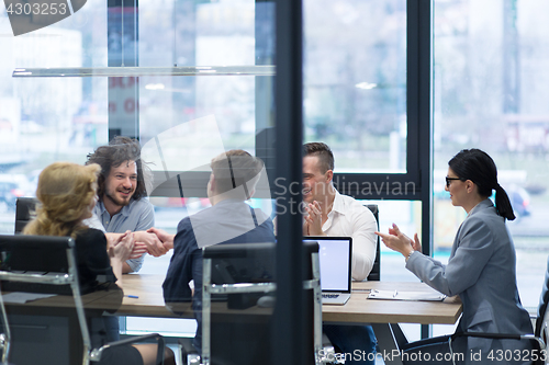 Image of cloasing the deal in modern office interior