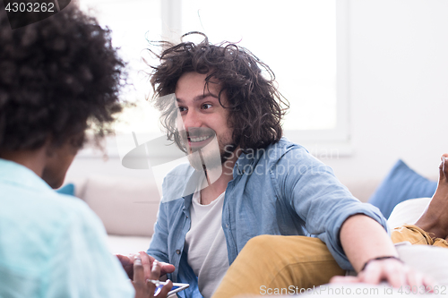 Image of multiethnic couple in living room
