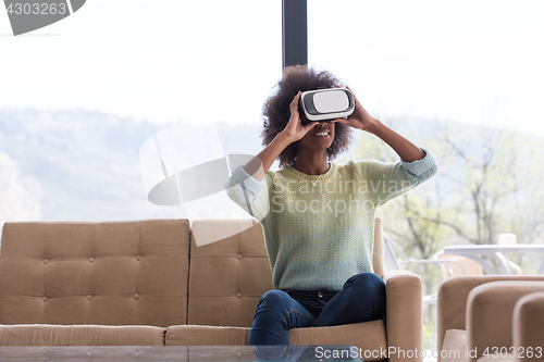 Image of black woman using VR headset glasses of virtual reality