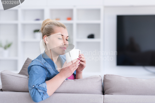 Image of woman enjoying a cup of coffee