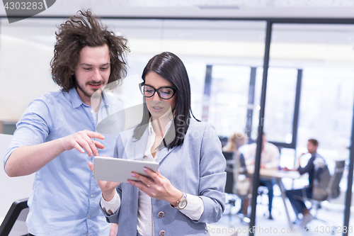 Image of Business People Working With Tablet in startup office