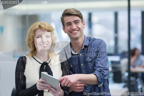 Image of Business People Working With Tablet in startup office