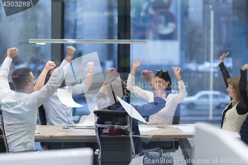 Image of startup Group of young business people throwing documents