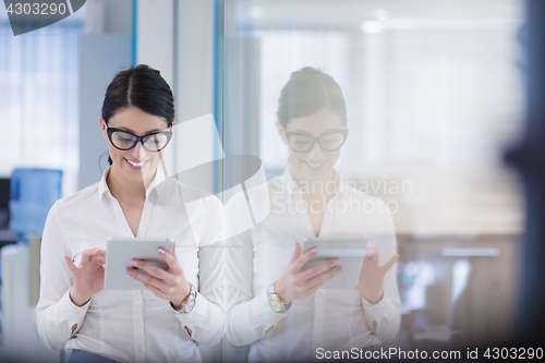 Image of Business Woman Using Digital Tablet in front of startup Office