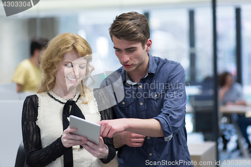 Image of Business People Working With Tablet in startup office