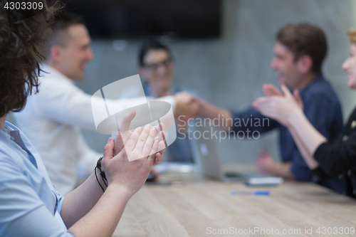 Image of cloasing the deal in modern office interior