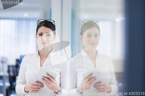 Image of Business Woman Using Digital Tablet in front of startup Office