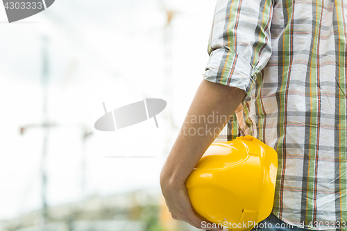 Image of Photo of builder with helmet