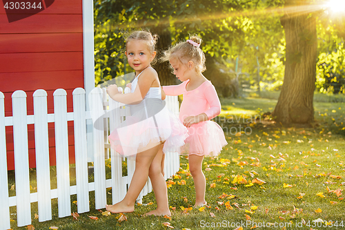 Image of The two little girls at playground against park or green forest