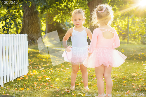 Image of The two little girls at playground against park or green forest