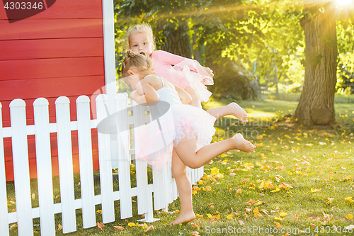 Image of The two little girls at playground against park or green forest