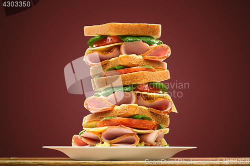Image of Croissants sandwiches on the wooden cutting board