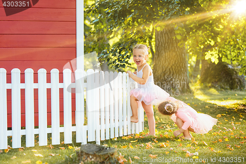 Image of The two little girls at playground against park or green forest